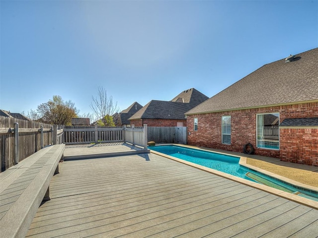 1217 Camelot Dr, Yukon, OK 73099 - view of swimming pool with a fenced backyard, a deck, and a fenced in pool