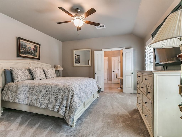 bedroom with vaulted ceiling, visible vents, a ceiling fan, and light colored carpet