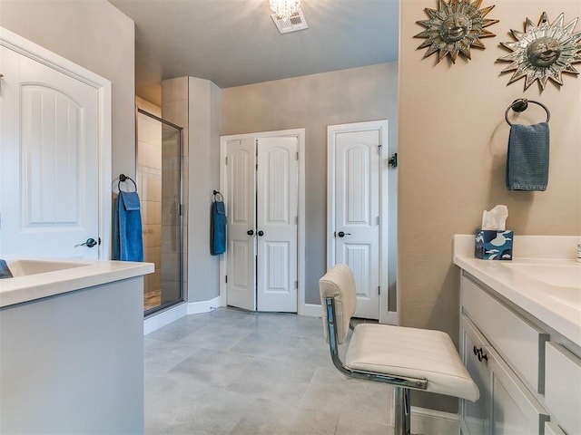 bathroom with a shower stall, baseboards, vanity, and visible vents