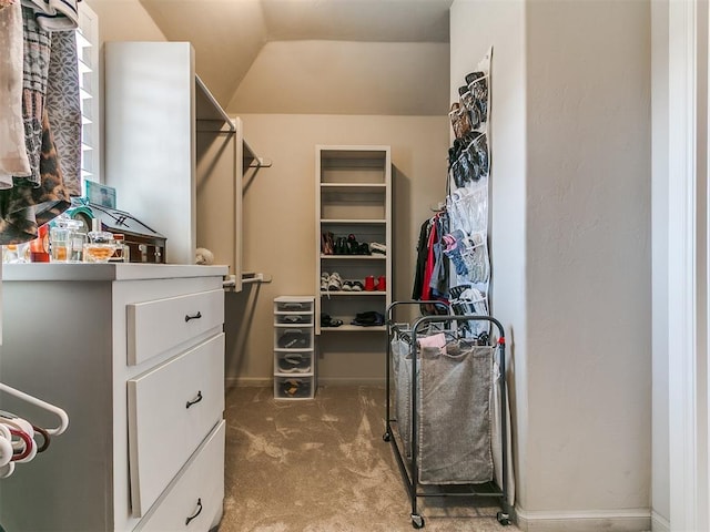 spacious closet with lofted ceiling and carpet