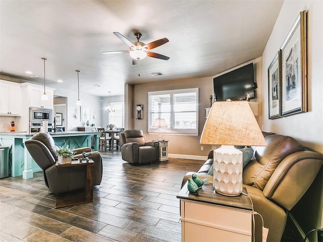 living room featuring dark wood finished floors, baseboards, visible vents, recessed lighting, and ceiling fan