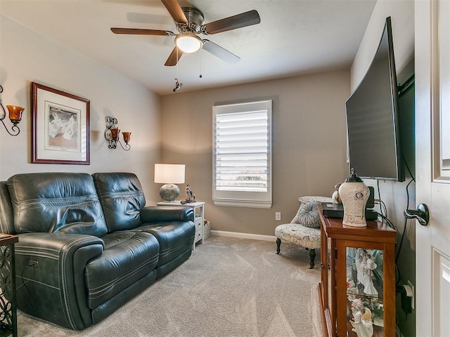 living area with carpet floors, a ceiling fan, and baseboards