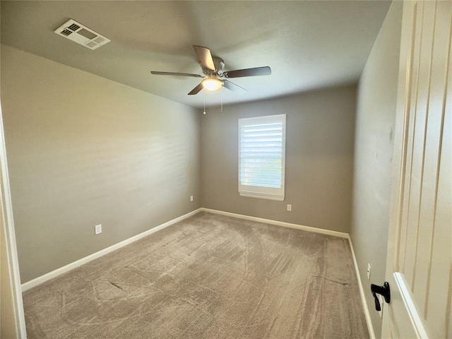 carpeted spare room featuring ceiling fan, baseboards, and visible vents