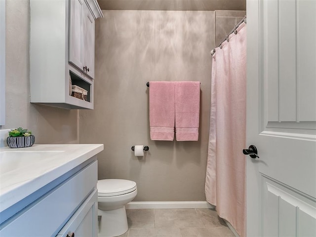 bathroom featuring tile patterned floors, toilet, vanity, a shower with curtain, and baseboards