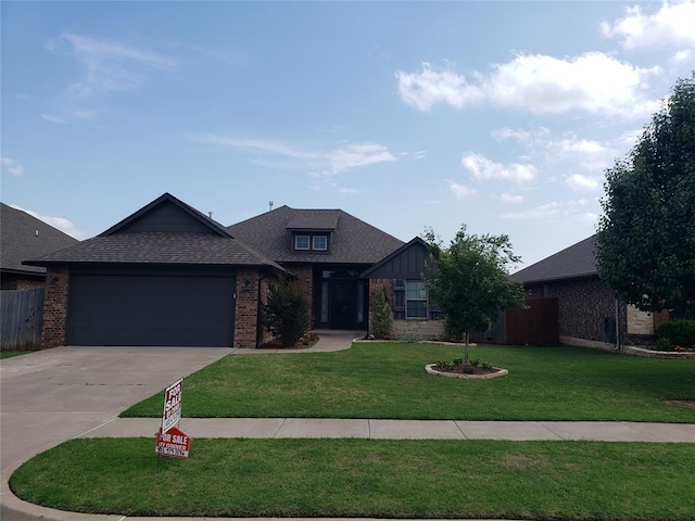 9908 SW 22nd St, Yukon, OK 73099 - view of front facade featuring brick siding, driveway, a garage, and roof with shingles