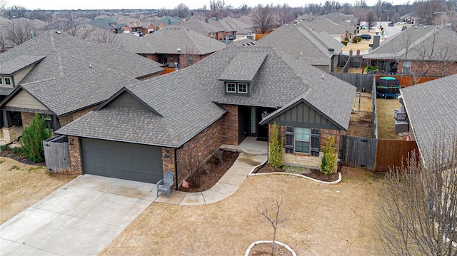 9908 SW 22nd St, Yukon, OK 73099 - view of front of home featuring a shingled roof, brick siding, a residential view, and an attached garage