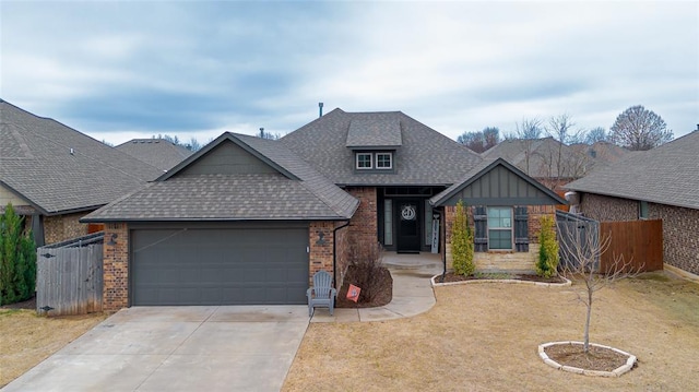 9908 SW 22nd St, Yukon, OK 73099 - view of front of house with brick siding, a shingled roof, a garage, and driveway