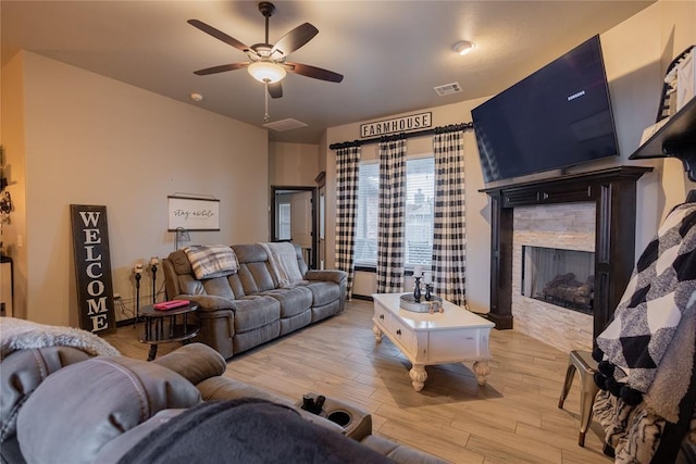 9908 SW 22nd St, Yukon, OK 73099 - living area with light wood-style floors, a fireplace, and a ceiling fan