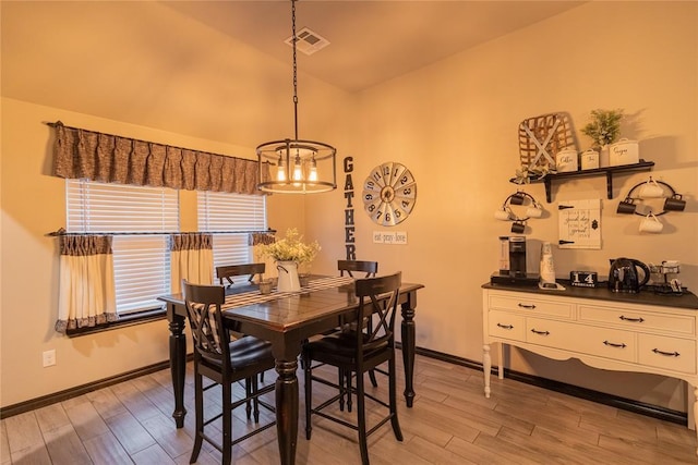 9908 SW 22nd St, Yukon, OK 73099 - dining space featuring a chandelier, light wood-style flooring, lofted ceiling, and baseboards