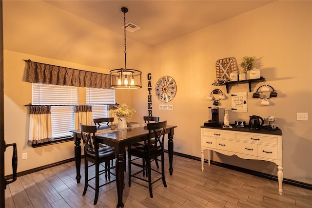 9908 SW 22nd St, Yukon, OK 73099 - dining room featuring a chandelier, light wood-style floors, lofted ceiling, and baseboards