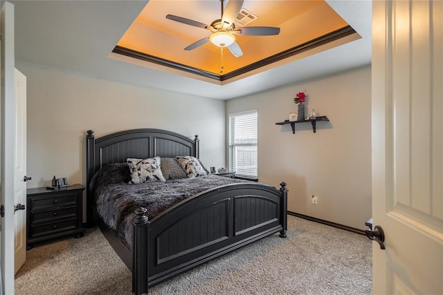 9908 SW 22nd St, Yukon, OK 73099 - carpeted bedroom featuring a raised ceiling, a ceiling fan, and baseboards