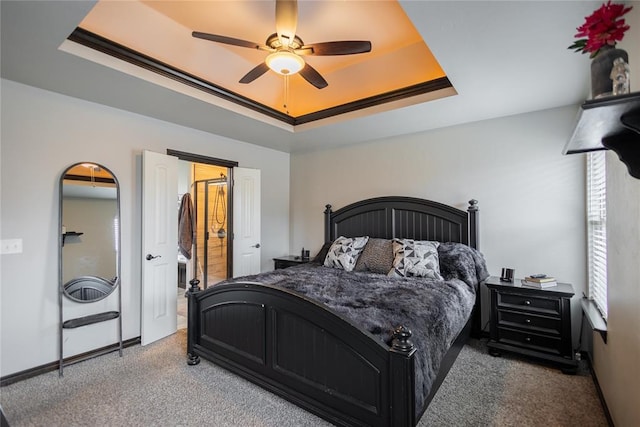 9908 SW 22nd St, Yukon, OK 73099 - bedroom featuring a tray ceiling, carpet flooring, baseboards, and ceiling fan