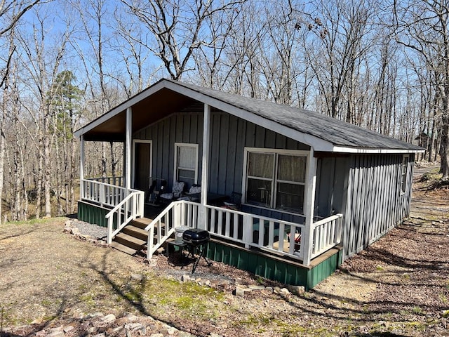 view of front facade with board and batten siding and covered porch
