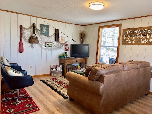 living room featuring crown molding and wood finished floors