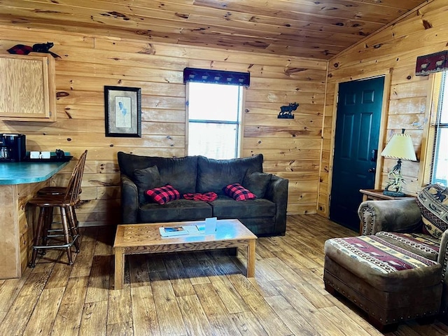 living room with wood walls, light wood finished floors, wood ceiling, and vaulted ceiling