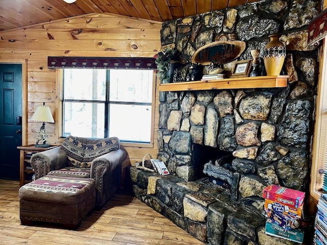sitting room with wood ceiling, wood finished floors, wooden walls, and vaulted ceiling