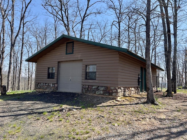 view of outbuilding with driveway and an outdoor structure