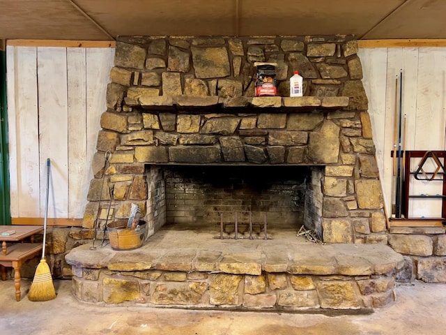 room details featuring concrete floors and a fireplace