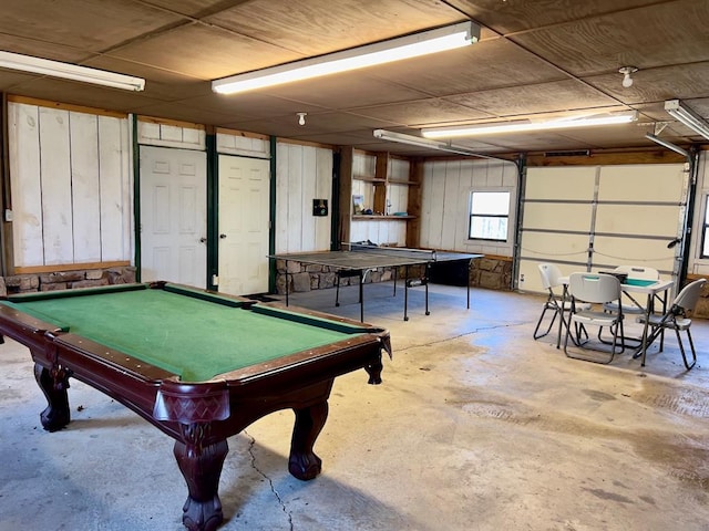 recreation room with concrete flooring, a garage, and billiards