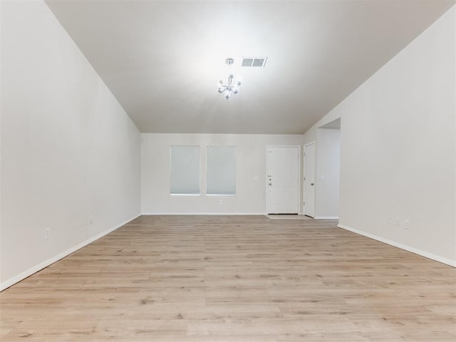1801 NW 145th St, Edmond, OK 73013 - unfurnished living room featuring lofted ceiling, visible vents, light wood-style floors, baseboards, and a notable chandelier