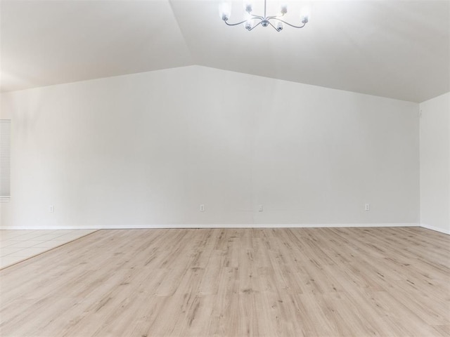 1801 NW 145th St, Edmond, OK 73013 - bonus room featuring an inviting chandelier, vaulted ceiling, light wood finished floors, and baseboards