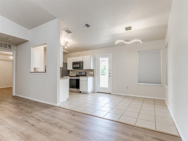 1801 NW 145th St, Edmond, OK 73013 - kitchen with white cabinets, black microwave, visible vents, and electric range