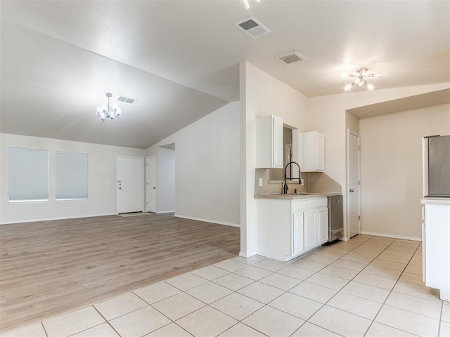 1801 NW 145th St, Edmond, OK 73013 - kitchen featuring light countertops, visible vents, an inviting chandelier, and white cabinetry