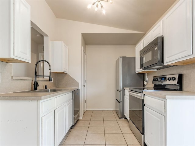 1801 NW 145th St, Edmond, OK 73013 - kitchen featuring a sink, light tile patterned flooring, stainless steel appliances, light countertops, and white cabinets