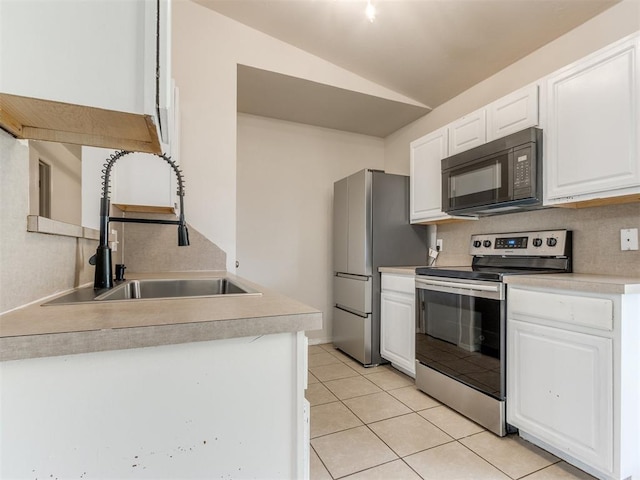 1801 NW 145th St, Edmond, OK 73013 - kitchen featuring vaulted ceiling, white cabinetry, stainless steel appliances, and a sink