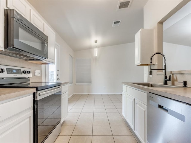1801 NW 145th St, Edmond, OK 73013 - kitchen with white cabinetry, stainless steel appliances, visible vents, and a sink