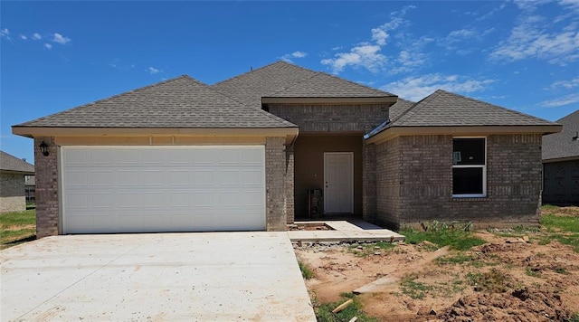 2416 Kathleens Xing, Yukon, OK 73099 - view of front of property featuring brick siding, concrete driveway, a garage, and a shingled roof