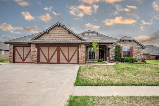 9609 Lakecrest Dr, Oklahoma City, OK 73159 - view of front of home with an attached garage, concrete driveway, a front lawn, and brick siding