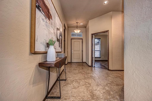 9609 Lakecrest Dr, Oklahoma City, OK 73159 - entryway featuring stone finish floor, a textured wall, and baseboards