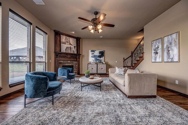 9609 Lakecrest Dr, Oklahoma City, OK 73159 - living area featuring stairway, a stone fireplace, a ceiling fan, and wood finished floors