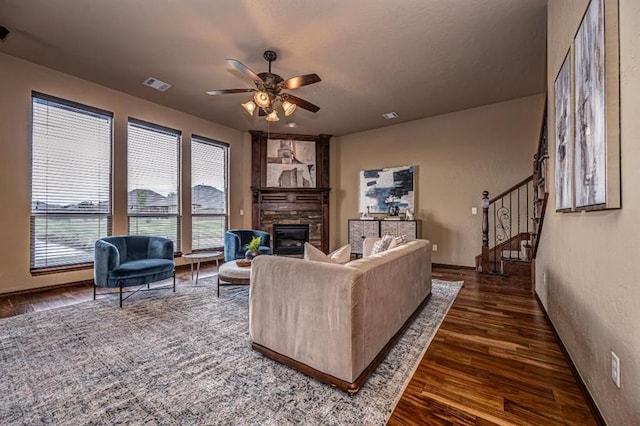 9609 Lakecrest Dr, Oklahoma City, OK 73159 - living room with a fireplace, a ceiling fan, stairs, dark wood-type flooring, and visible vents