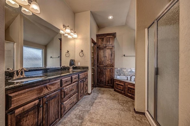 9609 Lakecrest Dr, Oklahoma City, OK 73159 - full bathroom featuring a bath, a sink, a textured wall, a shower stall, and double vanity