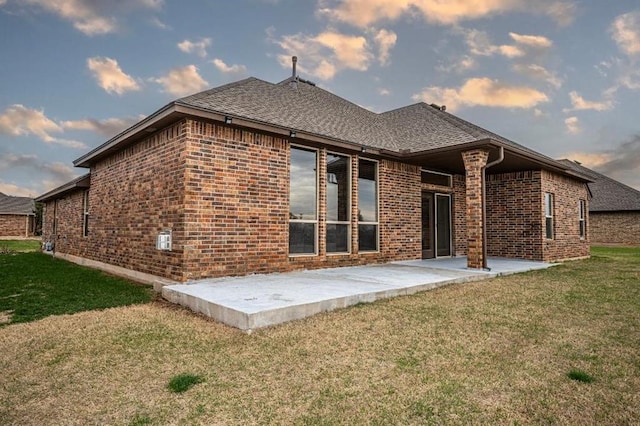 9609 Lakecrest Dr, Oklahoma City, OK 73159 - rear view of property with brick siding, a shingled roof, a lawn, and a patio area
