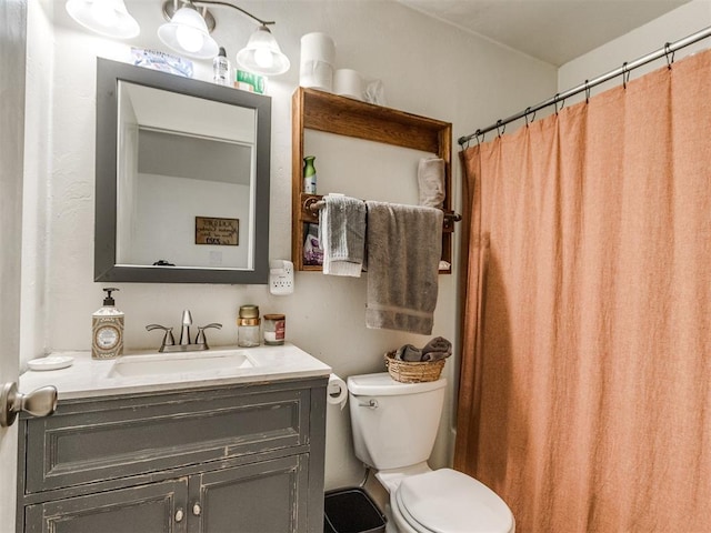 bathroom featuring a shower with shower curtain, toilet, and vanity