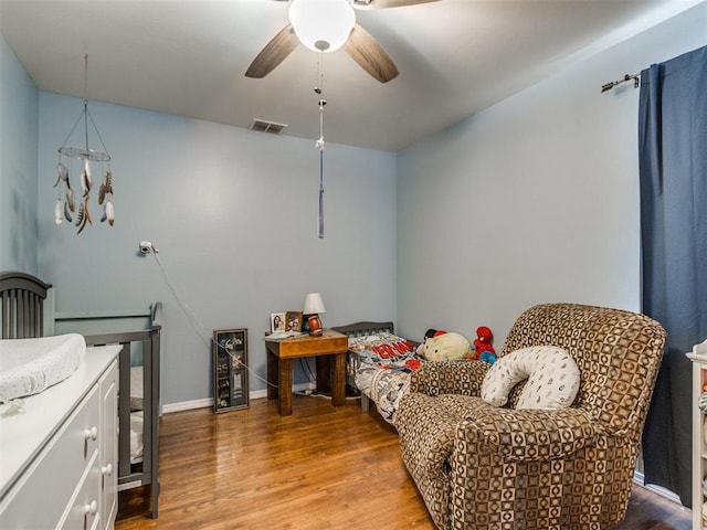 bedroom with wine cooler, light wood-type flooring, baseboards, visible vents, and ceiling fan
