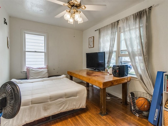 bedroom featuring a ceiling fan and wood finished floors