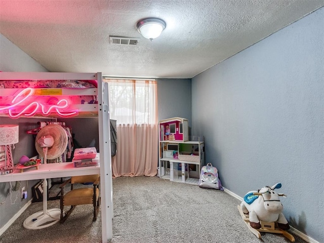 carpeted bedroom featuring baseboards, a textured wall, visible vents, and a textured ceiling