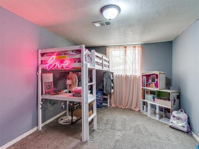 bedroom featuring a textured wall, a textured ceiling, visible vents, and carpet