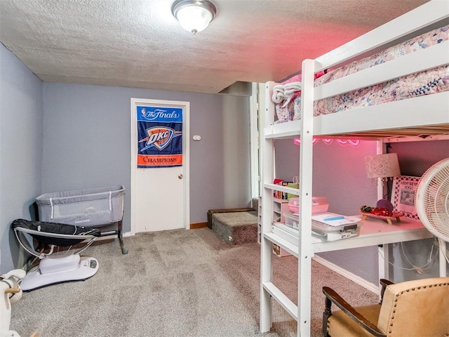 bedroom with carpet floors, a textured ceiling, and baseboards