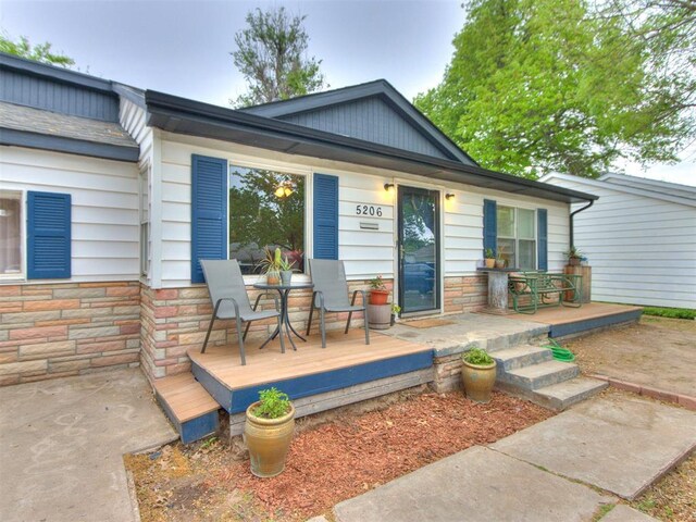 exterior space with stone siding and covered porch