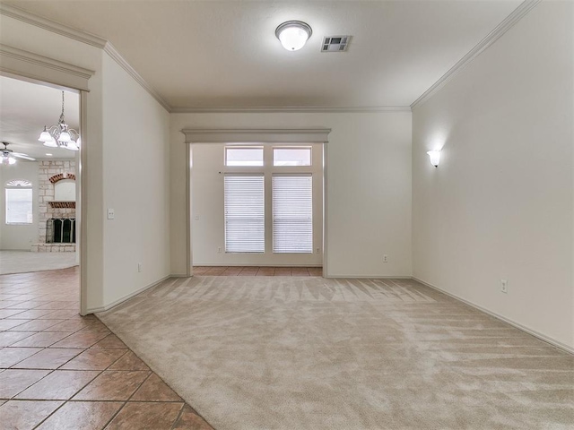 9333 SW 22nd St, Oklahoma City, OK 73128 - unfurnished room featuring visible vents, light carpet, crown molding, a fireplace, and ceiling fan with notable chandelier