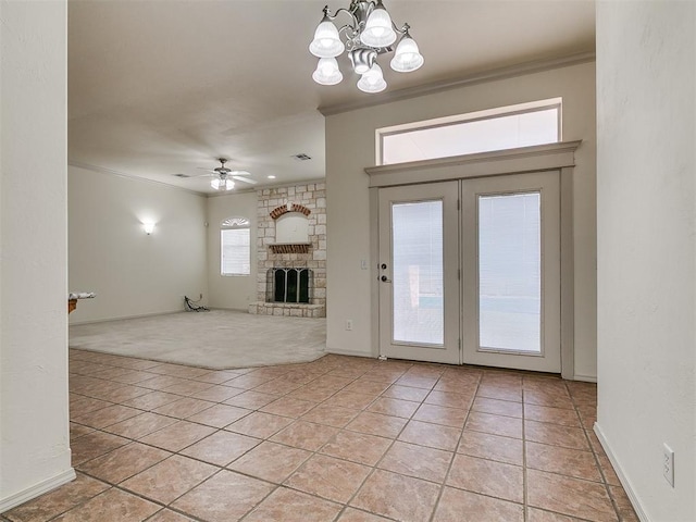 9333 SW 22nd St, Oklahoma City, OK 73128 - unfurnished living room with light tile patterned flooring, a stone fireplace, ornamental molding, and ceiling fan with notable chandelier
