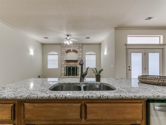 9333 SW 22nd St, Oklahoma City, OK 73128 - kitchen featuring brown cabinetry, open floor plan, ornamental molding, and a sink