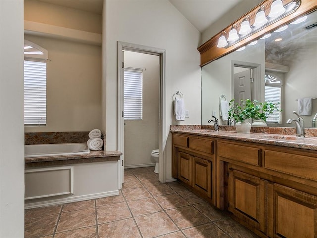 9333 SW 22nd St, Oklahoma City, OK 73128 - bathroom featuring vaulted ceiling, double vanity, toilet, a sink, and a bath