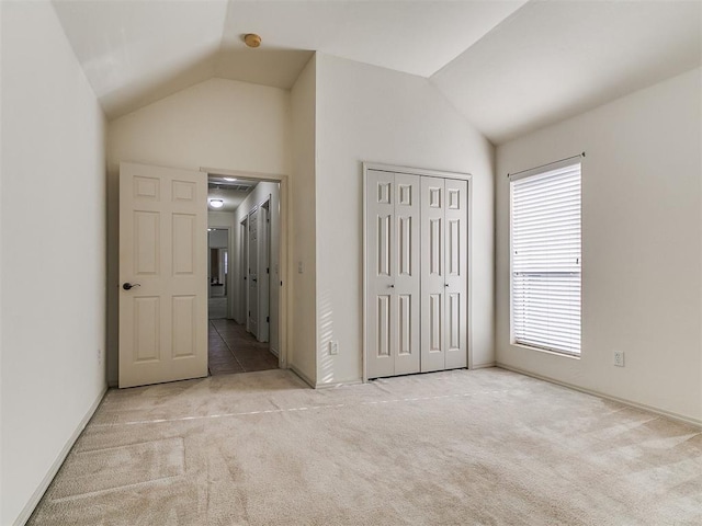 9333 SW 22nd St, Oklahoma City, OK 73128 - unfurnished bedroom with vaulted ceiling, a closet, and carpet