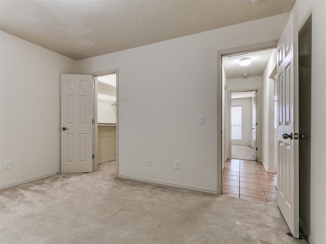 9333 SW 22nd St, Oklahoma City, OK 73128 - unfurnished bedroom with light carpet, baseboards, a spacious closet, and light tile patterned floors